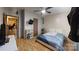 Cozy bedroom featuring wood-look flooring, a ceiling fan, and a television at 3379 Appletree Ct, Vale, NC 28168