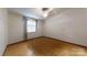 Empty bedroom featuring wood-look flooring, a ceiling fan, and a view of a window at 3379 Appletree Ct, Vale, NC 28168