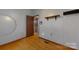 Bedroom with wood floors, featuring an attached bathroom and shelf with a mirror at 3379 Appletree Ct, Vale, NC 28168