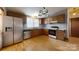 Kitchen with wood cabinets, wood floors, and stainless steel appliances at 3379 Appletree Ct, Vale, NC 28168