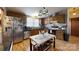 Kitchen with wood cabinets, wood floors, a stainless steel refrigerator, and a chandelier at 3379 Appletree Ct, Vale, NC 28168