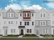 New townhome featuring varied materials, a dark front door, and professional landscaping at 4132 Skyboat Cir, Fort Mill, SC 29715