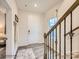 Inviting foyer with hardwood floors, a white front door, and an elegant staircase with metal spindles at 4140 Skyboat Cir, Fort Mill, SC 29715