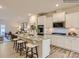 Stylish kitchen with a large island, white cabinets, stainless steel appliances, and an open view to the living area at 4140 Skyboat Cir, Fort Mill, SC 29715