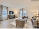 Cozy living room with large windows, stylish furnishings and hardwood style floors at 4140 Skyboat Cir, Fort Mill, SC 29715