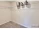 This walk-in closet features white walls, carpeted floors, and metal shelving for optimal storage at 4140 Skyboat Cir, Fort Mill, SC 29715
