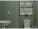 Modern half bathroom with a unique sink, stylish wall art, and a clean, minimalist design at 4539 Potters Wheel Dr, Fort Mill, SC 29715