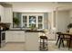 Modern kitchen featuring white cabinets, stainless steel appliances, an island with stool seating, and lots of natural light at 4539 Potters Wheel Dr, Fort Mill, SC 29715