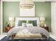 Staged main bedroom with light green walls and large decorative light fixture over the bed at 4567 Potters Wheel Dr, Fort Mill, SC 29715