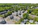 An aerial view showing the layout of a neighborhood with townhomes surrounded by mature trees at 5005 Sovereignty Ct, Charlotte, NC 28205
