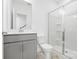 Stylish bathroom featuring a modern vanity, toilet, and walk-in shower with glass door at 5005 Sovereignty Ct, Charlotte, NC 28205
