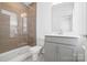 Stylish bathroom with a glass-enclosed shower, gray vanity, and modern fixtures at 5005 Sovereignty Ct, Charlotte, NC 28205