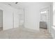Spacious bedroom featuring carpet, neutral walls, and adjacent bathroom and closet doors at 5005 Sovereignty Ct, Charlotte, NC 28205