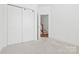 Bright bedroom boasts new carpet, closet, and an open door at 5005 Sovereignty Ct, Charlotte, NC 28205