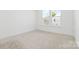 Well-lit bedroom with carpet and a large window at 5005 Sovereignty Ct, Charlotte, NC 28205