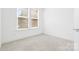 Cozy bedroom featuring neutral carpet and ample natural light at 5005 Sovereignty Ct, Charlotte, NC 28205