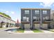 Street view of modern townhomes with dark gray siding, balconies, garages, and neat landscaping at 5005 Sovereignty Ct, Charlotte, NC 28205