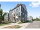 An eye-level exterior shot showcasing the townhouse, its stylish facade, and well-kept landscaping at 5005 Sovereignty Ct, Charlotte, NC 28205