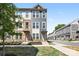 Beautiful townhome showcasing a well-manicured lawn, brick accents, and a modern facade at 5005 Sovereignty Ct, Charlotte, NC 28205