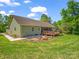 A spacious backyard with a wooden deck and fire pit, great for entertaining outdoors at 575 Hill Rd, Lincolnton, NC 28092