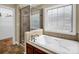 Bathroom featuring a large tub, shower, and window offering great natural light at 575 Hill Rd, Lincolnton, NC 28092