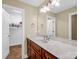 Bathroom with long vanity and sink featuring a walk-in closet and ample lighting at 575 Hill Rd, Lincolnton, NC 28092