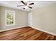 Bedroom has wood floor, large window and a ceiling fan at 575 Hill Rd, Lincolnton, NC 28092