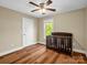 Bedroom features wood floors, a window, a ceiling fan, and a crib at 575 Hill Rd, Lincolnton, NC 28092