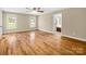 Bright bedroom featuring hardwood floors, a ceiling fan, and two windows at 575 Hill Rd, Lincolnton, NC 28092