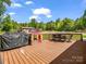 Spacious wooden deck with outdoor seating, grill, playhouse and wooded backyard at 575 Hill Rd, Lincolnton, NC 28092
