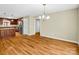 Dining area with hardwood floors, modern light fixture, and an open view of the kitchen at 575 Hill Rd, Lincolnton, NC 28092