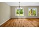 Dining area with ample sunlight, hardwood floors, and a view of the front yard at 575 Hill Rd, Lincolnton, NC 28092