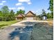 Spacious driveway leading to home with lush green lawn, a front porch, and attached two-car garage at 575 Hill Rd, Lincolnton, NC 28092