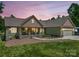 Charming single-Gathering home with well-maintained lawn, covered porch and 2-car garage at dusk at 575 Hill Rd, Lincolnton, NC 28092