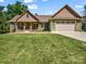 Charming home featuring a covered front porch, two-car garage and a well-manicured lawn at 575 Hill Rd, Lincolnton, NC 28092