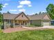 Beautiful home with a lush green lawn, a covered front porch, and attached two-car garage at 575 Hill Rd, Lincolnton, NC 28092