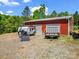 Detached red garage building with two bays, trailer and survival trailer at 575 Hill Rd, Lincolnton, NC 28092