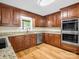 Well-lit kitchen features stainless steel appliances, granite counters, and wooden cabinets at 575 Hill Rd, Lincolnton, NC 28092