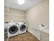 Modern laundry room equipped with new washer, dryer, and utility sink at 575 Hill Rd, Lincolnton, NC 28092