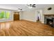 Bright living room featuring a stone fireplace, hardwood floors, and large front windows at 575 Hill Rd, Lincolnton, NC 28092