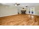 Cozy living room showcasing a stone fireplace, hardwood floors, and plenty of natural light at 575 Hill Rd, Lincolnton, NC 28092
