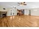 Open-concept living area with hardwood floors, stone fireplace, and access to the backyard at 575 Hill Rd, Lincolnton, NC 28092
