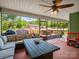 Enclosed porch featuring an outdoor sofa and scenic view at 575 Hill Rd, Lincolnton, NC 28092