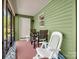 Enclosed porch area with table, chairs and ceiling fan at 575 Hill Rd, Lincolnton, NC 28092