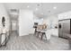 Modern kitchen with white cabinets, stainless steel appliances, granite countertops, and an island with bar stool seating at 5828 Patton St, Charlotte, NC 28269