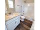 Modern bathroom featuring white vanity with granite countertop, toilet, and a shower-tub combo with a shower head at 606 E Carpenter St, Dallas, NC 28034