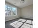 Sunlit bedroom with neutral walls, carpet flooring, and a large window offering a bright and airy space at 606 E Carpenter St, Dallas, NC 28034