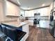 Well-lit kitchen featuring white cabinets, granite countertops, stainless steel appliances, and modern breakfast bar at 606 E Carpenter St, Dallas, NC 28034