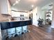 Bright, open kitchen with white cabinetry, granite counters, stainless appliances, and bar seating area at 606 E Carpenter St, Dallas, NC 28034
