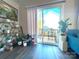 Inviting living room featuring wood floors, natural light, and sliding glass doors leading to an outdoor deck at 606 E Carpenter St, Dallas, NC 28034